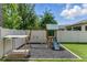Backyard play area featuring a slide, swing set, sandbox, and protective ground cover at 18596 Rococo Rd, Spring Hill, FL 34610