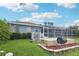 Spacious backyard with a built-in grill, large patio, and mature landscaping at 18712 Forest Glen Ct, Tampa, FL 33647