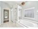Beautiful bathroom boasts a soaking tub, glass-enclosed shower, and well-lit vanity area with ample natural light at 18712 Forest Glen Ct, Tampa, FL 33647