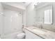 Cozy bathroom featuring white tile, granite vanity, and updated fixtures at 18712 Forest Glen Ct, Tampa, FL 33647