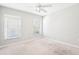 Bright bedroom with natural light, neutral walls, and a ceiling fan at 18712 Forest Glen Ct, Tampa, FL 33647