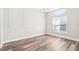 Bedroom with hardwood floors, white trim and ample sunlight with space for customization and decor at 18712 Forest Glen Ct, Tampa, FL 33647