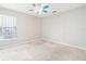 Neutral bedroom with carpet, lighted ceiling fan and view from the window at 18712 Forest Glen Ct, Tampa, FL 33647