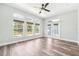 Bright bedroom with modern furniture, hardwood floors, ample natural light and a view of the pool from the french doors at 18712 Forest Glen Ct, Tampa, FL 33647