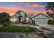 Charming home exterior with two car garage and well-manicured lawn at 18712 Forest Glen Ct, Tampa, FL 33647