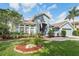 Charming single-Gathering home featuring a well-maintained lawn and inviting curb appeal in a quiet residential neighborhood at 18712 Forest Glen Ct, Tampa, FL 33647