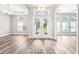 Bright foyer boasts natural light, elegant chandelier, beautiful hardwood floors, and inviting double door entry at 18712 Forest Glen Ct, Tampa, FL 33647