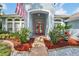 Inviting front entrance with a red double door and lush landscaping welcomes you home at 18712 Forest Glen Ct, Tampa, FL 33647