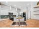 Kitchen with stainless steel appliances, tiled backsplash, wooden countertop, island with towel rack, and open concept design at 18712 Forest Glen Ct, Tampa, FL 33647