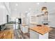 Modern kitchen featuring butcher block countertops, stainless steel appliances, an island, stylish pendant lights, and open shelving at 18712 Forest Glen Ct, Tampa, FL 33647