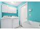 Laundry room with washer, dryer, utility sink, and cabinet storage at 18712 Forest Glen Ct, Tampa, FL 33647