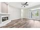 Bright living room featuring modern fireplace, wood-look floors, and seamless access to the outdoors at 18712 Forest Glen Ct, Tampa, FL 33647