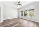 Bright room with hardwood floors and ample natural light from large windows overlooking the outdoor scenery at 18712 Forest Glen Ct, Tampa, FL 33647