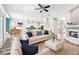 Bright, open-concept living room with hardwood floors, fireplace, modern furnishings, and seamless flow into dining and kitchen areas at 18712 Forest Glen Ct, Tampa, FL 33647