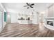 Spacious living area with wood floors connecting to the updated kitchen and cozy fireplace at 18712 Forest Glen Ct, Tampa, FL 33647