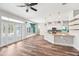 Open-concept living space boasts wood floors, plenty of natural light, and a seamless flow to the modern kitchen at 18712 Forest Glen Ct, Tampa, FL 33647