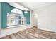 Cozy living space with a window seat, wood floors, and pool views at 18712 Forest Glen Ct, Tampa, FL 33647