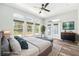 Bright main bedroom with modern furniture, hardwood floors, and a view of the pool from the french doors at 18712 Forest Glen Ct, Tampa, FL 33647