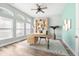 Bright home office with a modern wood desk, built-in shelving, stylish decor, and an airy, functional workspace at 18712 Forest Glen Ct, Tampa, FL 33647