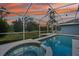 Screened pool and jacuzzi with scenic backyard views at 18712 Forest Glen Ct, Tampa, FL 33647