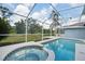 Beautiful backyard featuring a pool, spa, and screened-in lanai at 18712 Forest Glen Ct, Tampa, FL 33647