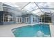 Backyard oasis featuring a screened-in pool, spa, and patio area at 18712 Forest Glen Ct, Tampa, FL 33647
