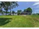 Expansive backyard featuring a pool, screened enclosure and lush green space with plenty of room to roam at 1899 Oak Park S Dr, Clearwater, FL 33764
