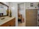 Bathroom vanity leading into a bedroom with neutral walls and a closet at 1899 Oak Park S Dr, Clearwater, FL 33764
