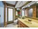 Stylish bathroom with a sink, vanity, toilet, and large mirror, plus a stand-up shower at 1899 Oak Park S Dr, Clearwater, FL 33764