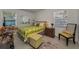 Bedroom with natural light, patterned bedding, side table, and chair at 1899 Oak Park S Dr, Clearwater, FL 33764