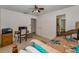 Light-filled bedroom featuring neutral walls, ceiling fan, and doorway to the en-suite bathroom at 1899 Oak Park S Dr, Clearwater, FL 33764