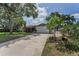 Long driveway leading to a charming single-story home with a two-car garage at 1899 Oak Park S Dr, Clearwater, FL 33764