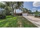 Charming single-story home with a large front yard, mature trees, and a brick facade at 1899 Oak Park S Dr, Clearwater, FL 33764