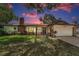 Charming brick home with a well-manicured lawn, gated entry, and attached two-car garage at 1899 Oak Park S Dr, Clearwater, FL 33764