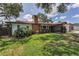 Charming brick home with a well-manicured lawn, gated entry, and an attached two-car garage at 1899 Oak Park S Dr, Clearwater, FL 33764