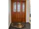 Elegant wood front door with decorative glass panels and sleek hardware at 1899 Oak Park S Dr, Clearwater, FL 33764