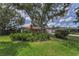 Lush landscaping and mature trees surround this charming single-story home at 1899 Oak Park S Dr, Clearwater, FL 33764