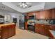 Spacious kitchen with stainless steel refrigerator, oven, microwave, and dark wood cabinets at 1899 Oak Park S Dr, Clearwater, FL 33764