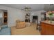Living area with speckled flooring, tv, and open floor plan view to the kitchen at 1899 Oak Park S Dr, Clearwater, FL 33764