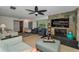 Inviting living room featuring a stone fireplace, comfortable seating, and a ceiling fan at 1899 Oak Park S Dr, Clearwater, FL 33764