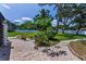 A cozy backyard patio area with lush landscaping, perfect for outdoor relaxation and entertainment at 1899 Oak Park S Dr, Clearwater, FL 33764