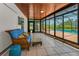 Enclosed lanai features screened windows, tile floors, comfortable seating, and access to pool at 1899 Oak Park S Dr, Clearwater, FL 33764