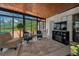 Sunroom features screened windows, an entertainment center, tile floors, and wicker furniture at 1899 Oak Park S Dr, Clearwater, FL 33764