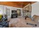 Covered lanai features tile floor, wood ceiling, television, and stylish furnishings at 1899 Oak Park S Dr, Clearwater, FL 33764