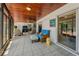 Enclosed lanai features tile floor, wood ceiling, stylish furnishings, and access to pool at 1899 Oak Park S Dr, Clearwater, FL 33764