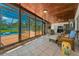 Spacious sunroom provides access to the pool, and features a wood ceiling, tile floor, and ample seating at 1899 Oak Park S Dr, Clearwater, FL 33764