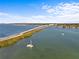Aerial view of a bridge spanning over water with boats, greenery, and a clear sky backdrop at 208 Live Oak Ln, Largo, FL 33770