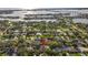 Breathtaking aerial view of a waterfront community showcasing lush greenery and the beautiful home's location near the bay at 208 Live Oak Ln, Largo, FL 33770