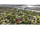 Aerial view of a residential area with lush greenery, waterfront access, and diverse architectural styles at 208 Live Oak Ln, Largo, FL 33770