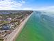 Aerial view of beautiful waterfront homes and shoreline at 208 Live Oak Ln, Largo, FL 33770